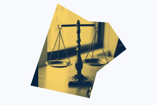 Yellow and dark blue graphic of scales of justice.