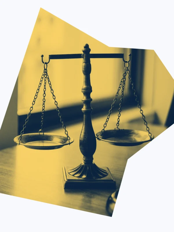 Yellow and dark blue graphic of scales of justice.