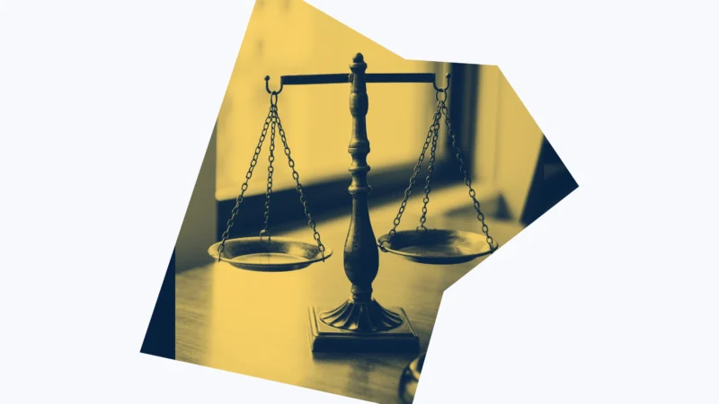Yellow and dark blue graphic of scales of justice.