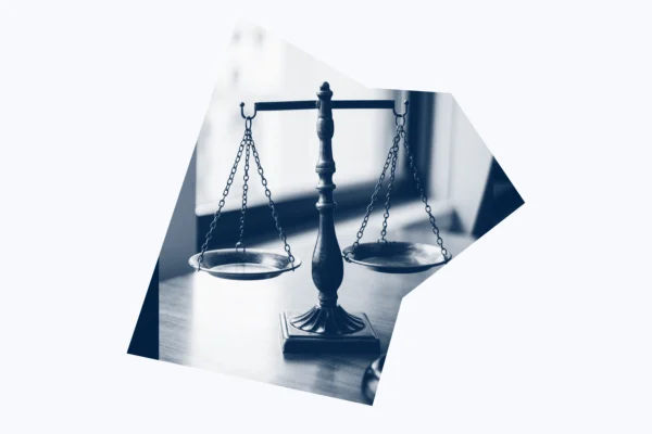 A dark blue and white graphic of scales of justice.