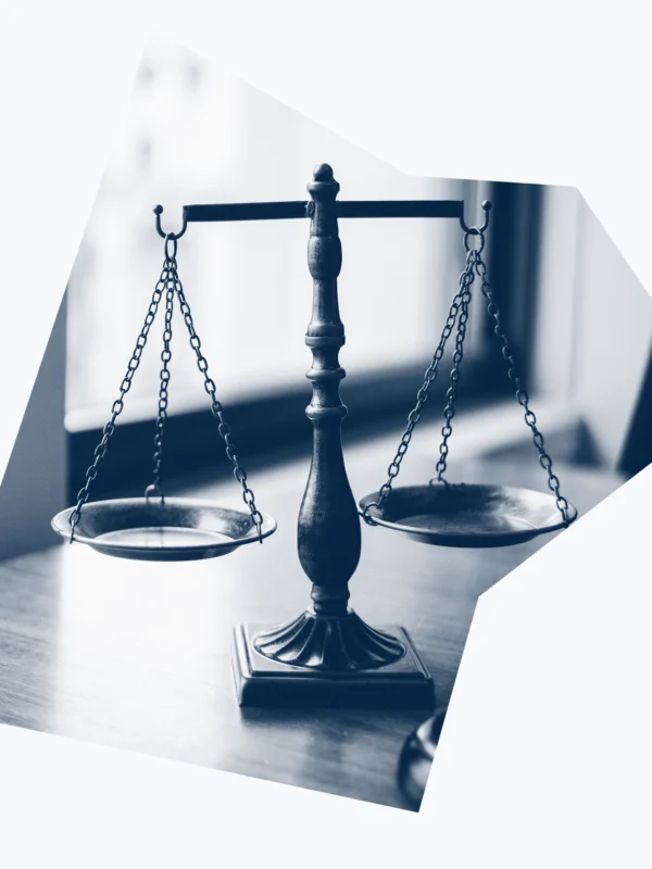 A dark blue and white graphic of scales of justice.