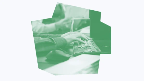 Bright green and white graphic of an office worker typing on a keyboard.