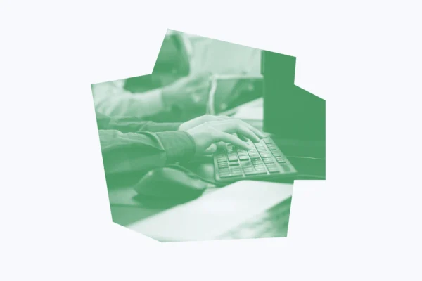 Bright green and white graphic of an office worker typing on a keyboard.