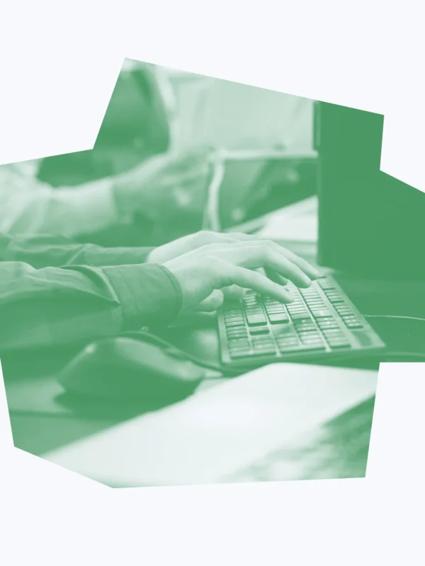 Bright green and white graphic of an office worker typing on a keyboard.