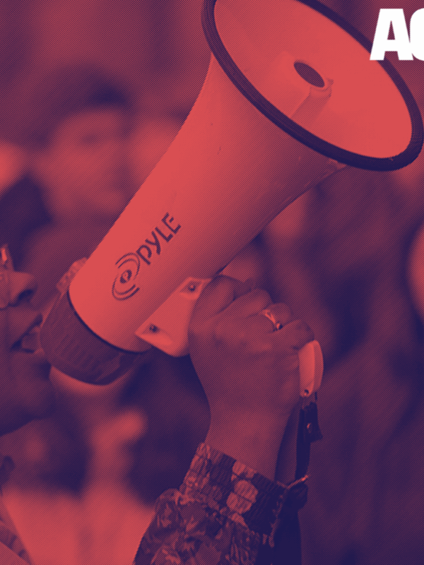 Red and blue photo of a student talking into a megaphone