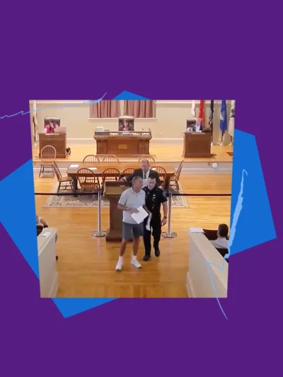 Robert Cote being led out of a Warwick Town Council meeting by a police officer, with purple and blue shapes and squiggles framing the image.
