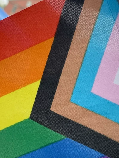 LGBTQ+ flag with trans pride colors.