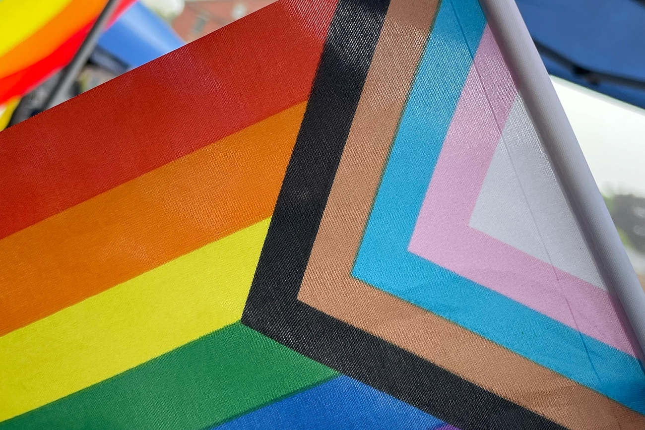LGBTQ+ flag with trans pride colors.